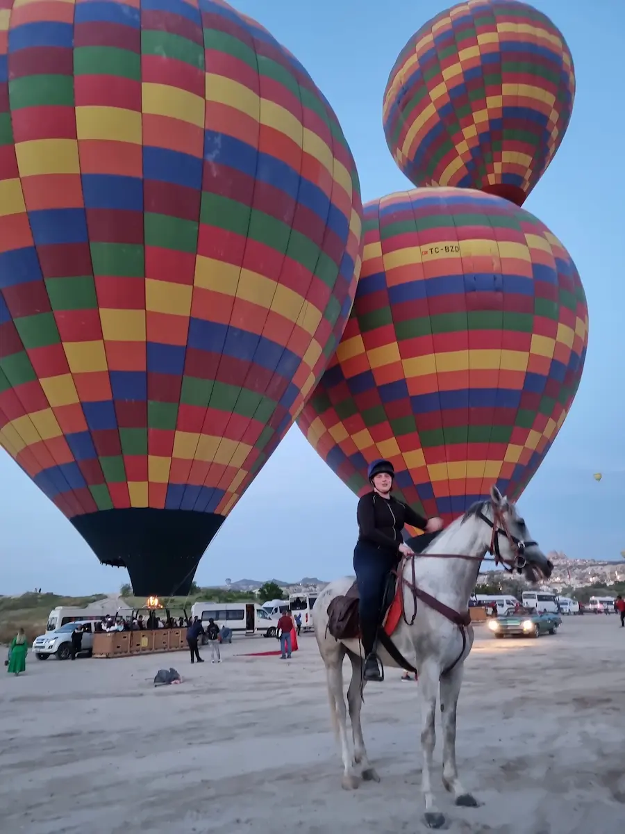 Horse riding in Cappadocia under hot air balloons